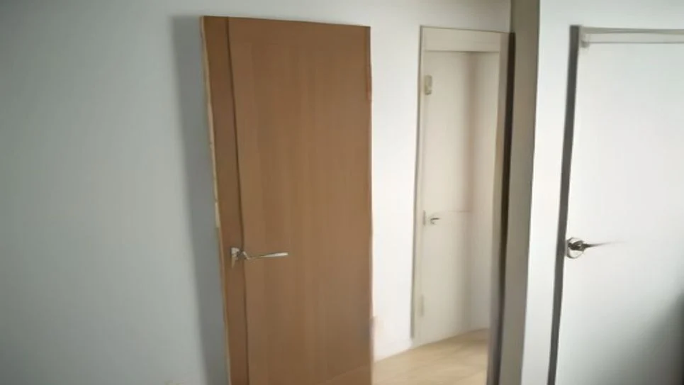 A draft stopper placed at the bottom of a bedroom door to prevent cold air